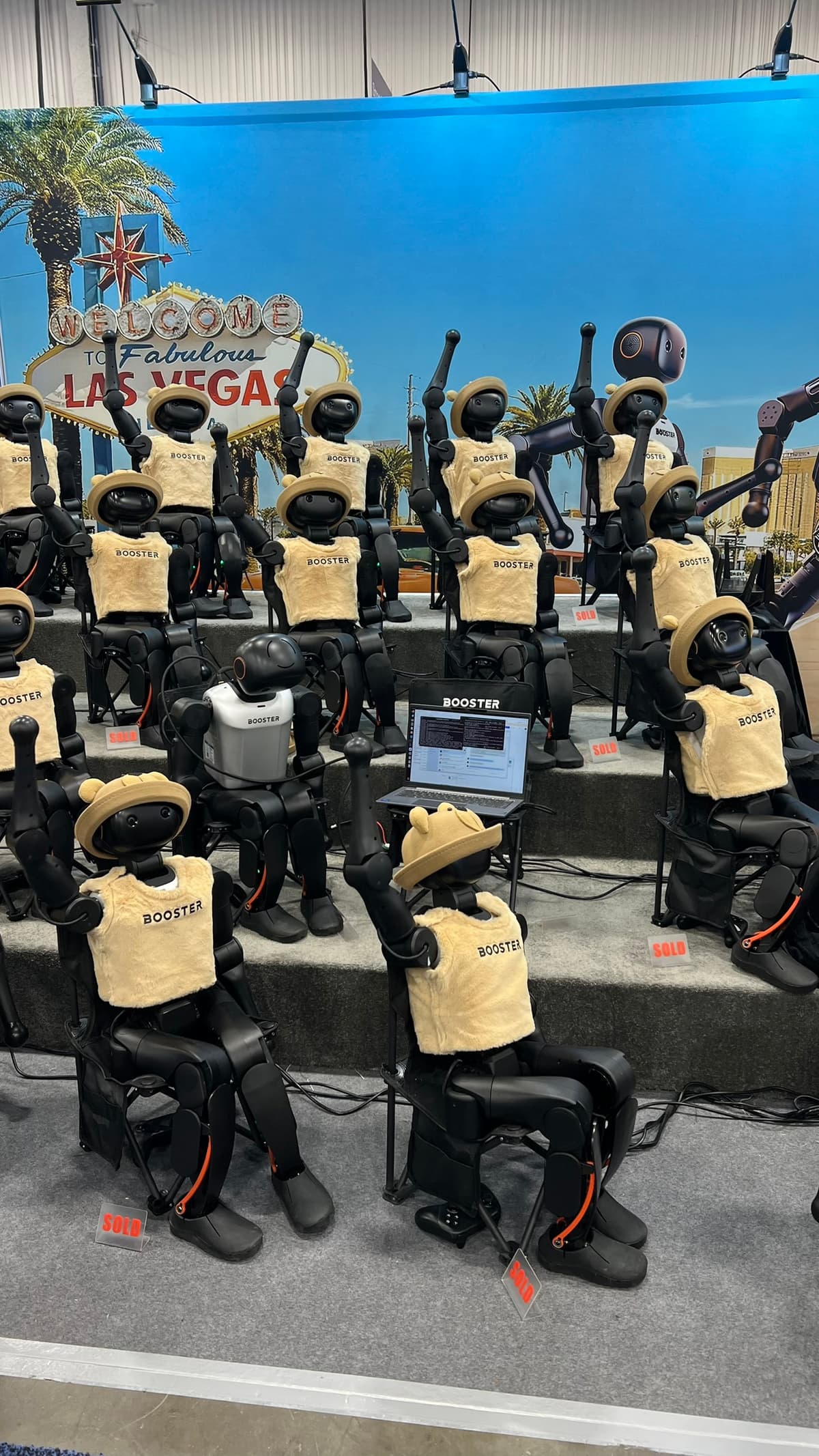 Booster humanoid robots with Vegas sign backdrop